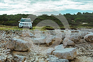 white suv between rocks. off road car travel concept