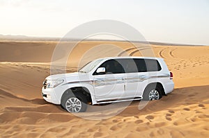 White SUV Toyota Land Cruiser in desert