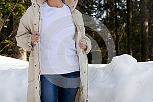 White sweatshirt mockup of a girl in beige quilted  jacket, model mockup