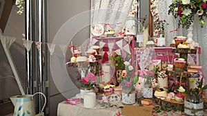 White sweets on gilded paper on the wedding candybar.