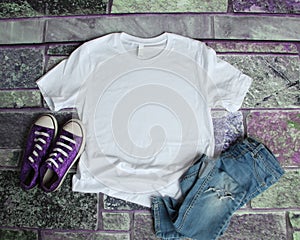 White T Shirt mockup flat lay on purple brick background with pu