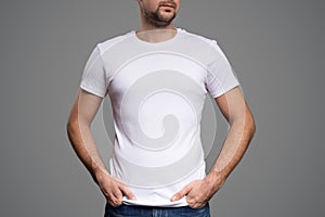 White t-shirt on a young man template. Gray background.