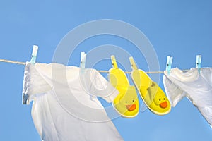 White t-shirts and slippers on the clothesline