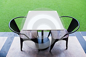 White table and black chair in coffee shop.