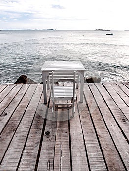 White table and chair on the beach 1