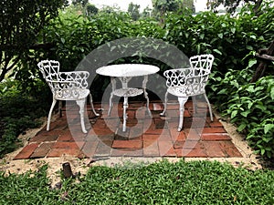 White table and chair in the garden.