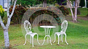 White table and chairs in a garden