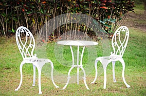 White table and chairs in a garden