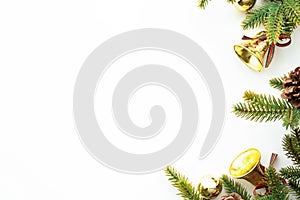 White table with Christmas decoration including pine branches and pine cones with golden balls. Merry Christmas and happy new year