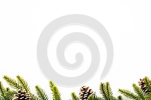 White table with Christmas decoration including pine branches and pine cones. Merry Christmas and happy new year concept. Top view
