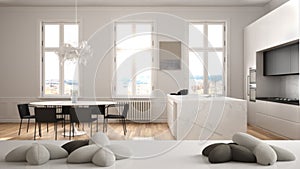 White table, desk or shelf with five soft white pillows in the shape of stars or flowers, over modern white kitchen dining table,
