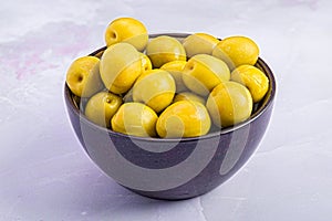 White table featuring a bowl filled with bright Manzanilla Olives photo