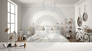 White table top or shelf with minimalistic bird ornament, birdie knick - knack over blurred scandinavian bedroom