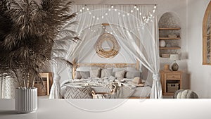 White table top or shelf with straws, dry plants, ornament, ears, sheaf, branch in vase, over bohemian bedroom with canopy bed,