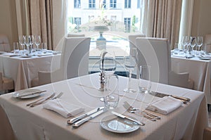 White tables with dinnerware