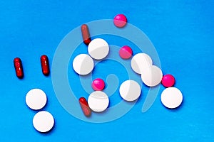 white tablets on blue background. top view