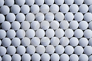 White tablets folded on a pharmaceutical factory production line