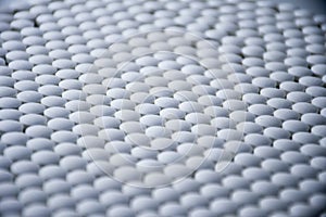 White tablets folded on a pharmaceutical factory production line