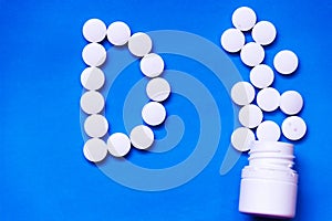 white tablets on purple background. top view