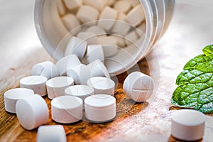 White tablets on wooden table