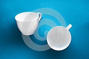 White tableware crockery set, empty cup on blue flatlay background