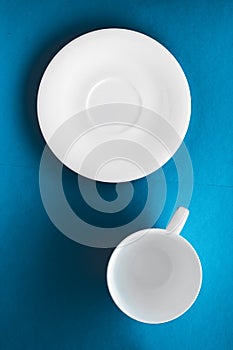 White tableware crockery set, empty cup on blue flatlay background