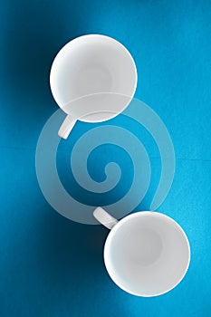 White tableware crockery set, empty cup on blue flatlay background