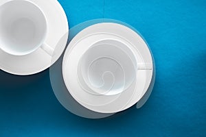 White tableware crockery set, empty cup on blue flatlay background