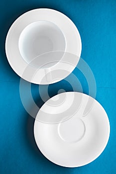 White tableware crockery set, empty cup on blue flatlay background