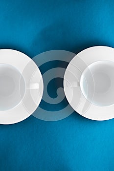 White tableware crockery set, empty cup on blue flatlay background