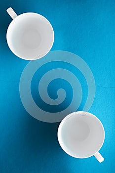 White tableware crockery set, empty cup on blue flatlay background