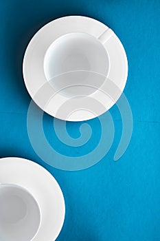 White tableware crockery set, empty cup on blue flatlay background