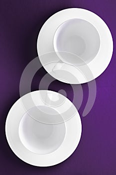 White tableware crockery set, empty cup on purple flatlay background