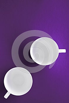 White tableware crockery set, empty cup on purple flatlay background