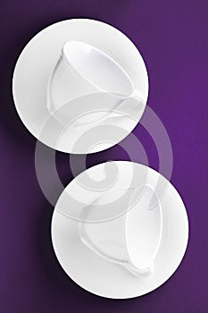 White tableware crockery set, empty cup on purple flatlay background