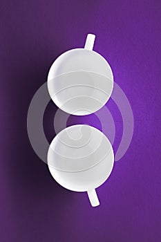 White tableware crockery set, empty cup on purple flatlay background