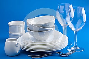 White tableware over blue background