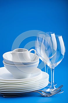 White tableware over blue background