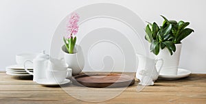 White tableware for serving. Crockery,dish, utensils and other different white stuff on white table-top. Kitchen still life. Copy