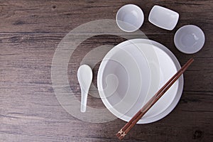 White tablewear set with chopsticks on wood table