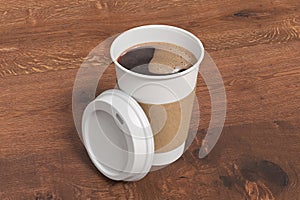 White take away coffee paper cup mock up with opened white lid with holder on wooden background