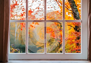 White tall window sill with autumn garden on background