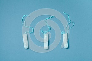 White tampons on blue background, menstruation