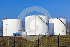 White tank in tank farm with blue