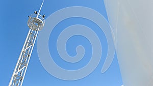 White tank and tower lighting on the sky background