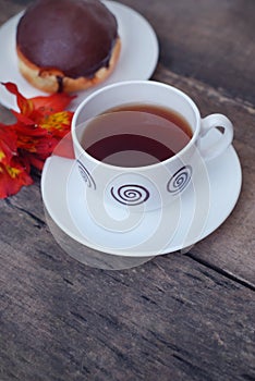 White Tea Cup Chocolate Donut Orange Red Flower Alstromeria Astromeria over Rustic Wooden Background. Copy space