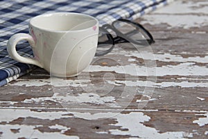 White tea cup and glasses on old wood table