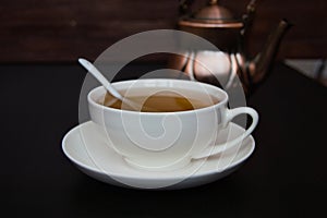 White tea cup with saucer and tea spoon