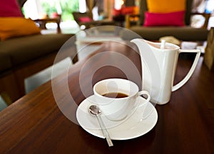 White tea pot and cup on the table
