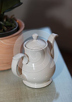 White tea pot on the table